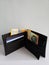 black leather wallet with Â swiss banknotes and white background